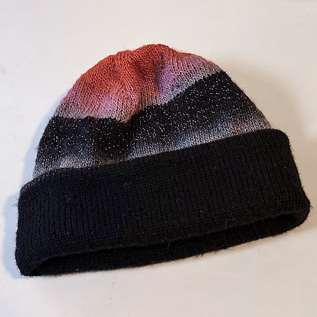 An orange, grey, and black hat